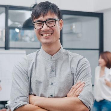 Asian man smiling working in Marten Marketing