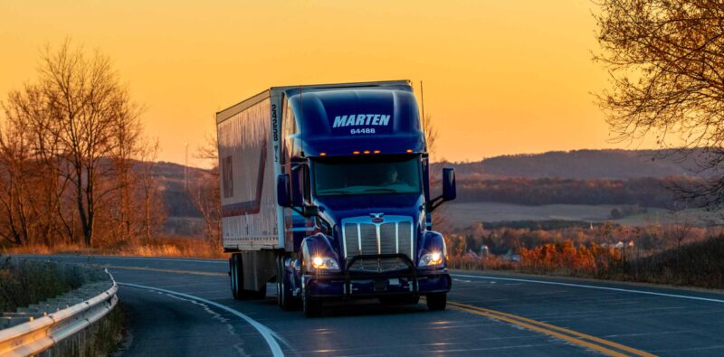 Marten truck driving with sunset in background
